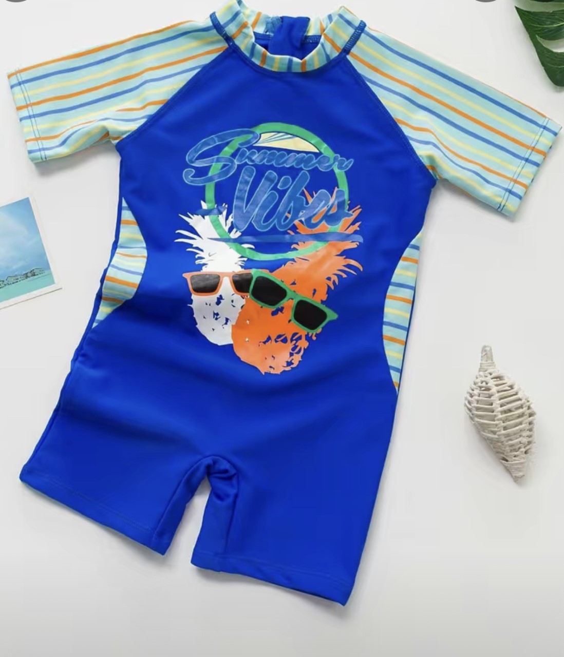 It’s time to bring the summer vibes in this Boys Shortie Rashguard Swimsuit! This pineapple with sunglasses design and adorable stripe sleeve and neck will have him ready for fun summer adventures. Plus, UPF 50 sun protection means his skin stays safe in the sun!