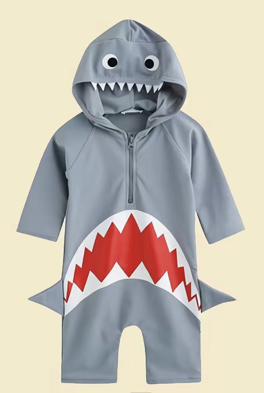 Your little man can be the king of the waves in this Shark Attack Long Sleeve Rashguard Boy's Swimsuit! Featuring a shark design with an open mouth and an attached  hood with awesome shark teeth and fin; your little guy will be swimming in style with UPF 50+ protection. Dive into adventure!