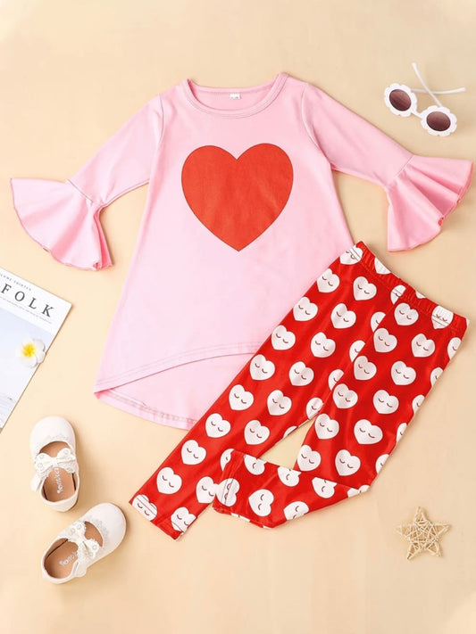 This adorable 2 piece pant set has our hearts fluttering. We love the adorable heart pattern on the elastic waist pant, as well as the bell sleeve and hi-low top with the single large heart! So adorable for your little Valentine, or any time of the year. 