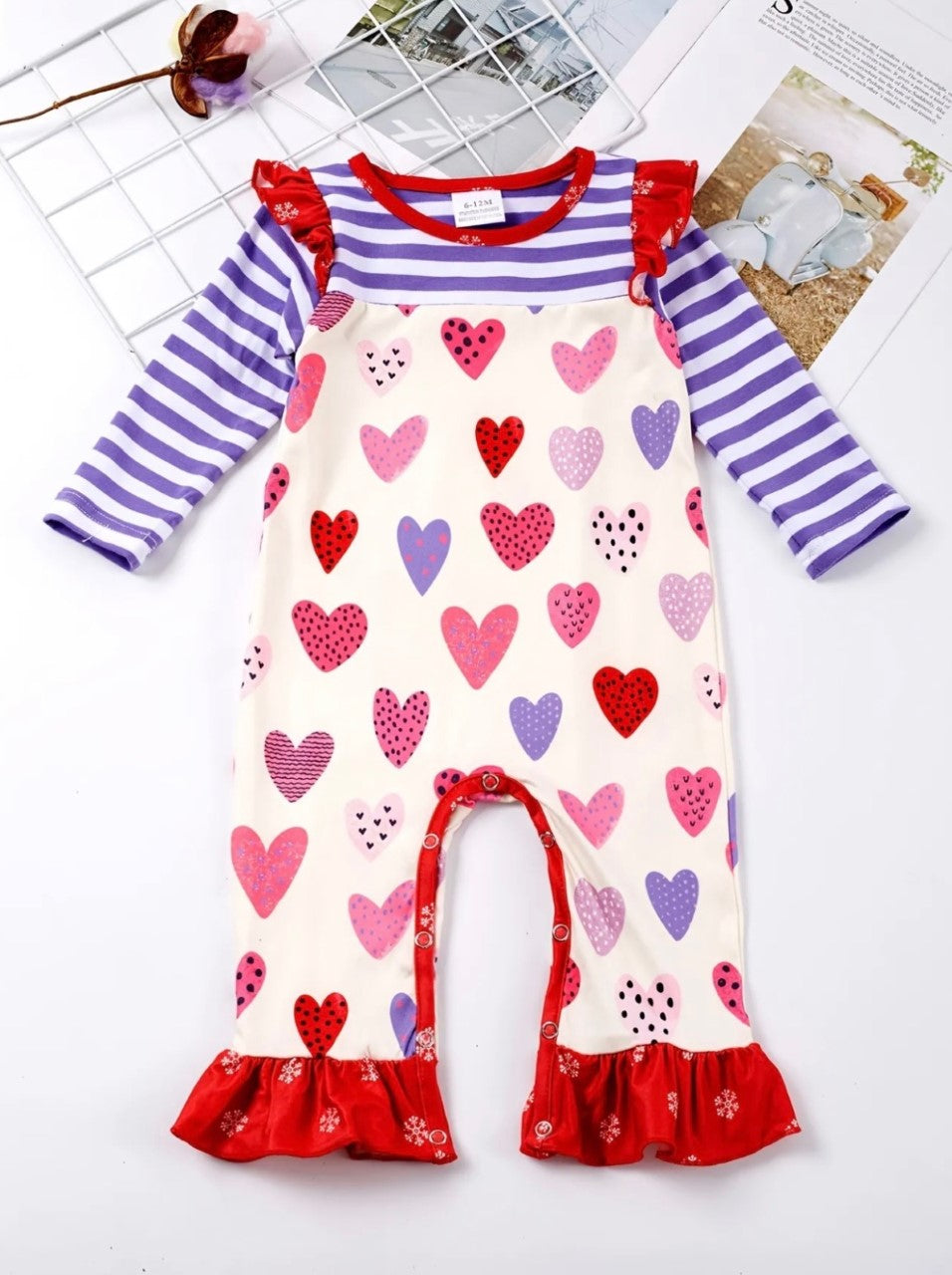 Hearts, stripes and ruffles, what could be better? This polka dot heart print in combination with the purple and white stripe fabric as well as red ruffle on the hem and shoulder are precious! I would wear it everyday!!